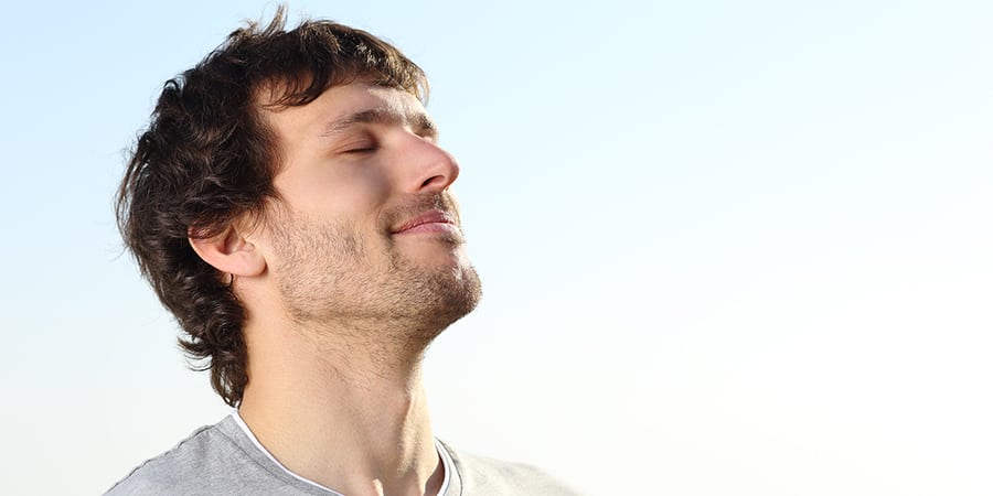 Capturing the essence of overcoming stress, an image of a man radiating relief and happiness in the journey of maintaining sobriety during challenging times.