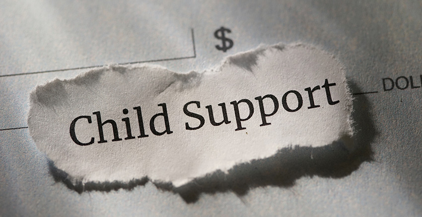 An image of a torn piece of paper over a budget, bearing the words 'Child Support,' symbolizing the blog's focus on understanding the financial aspects and commitments associated with child support.