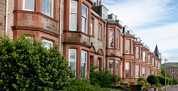 A row of homes symbolizes the vital connection explored in the blog on the link between homelessness and recidivism.