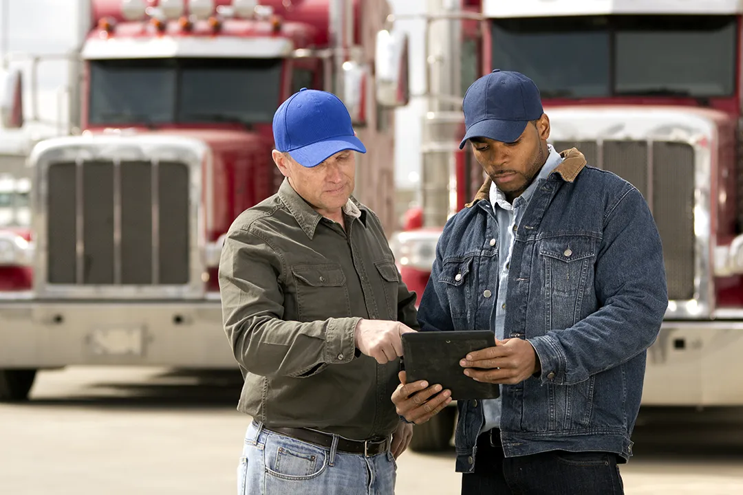 Second chance trucking: Two men performing a thorough pre-trip inspection for driver's equipment safety