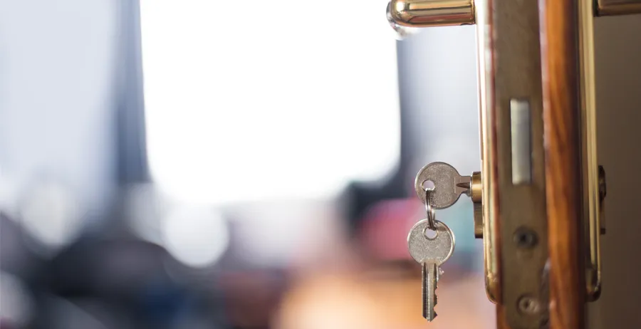 Keys dangle from the door of a new place to live thanks to housing assistance