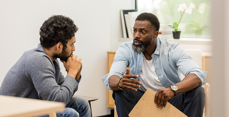 Image shows a mentor and mentee in deep discussion. 