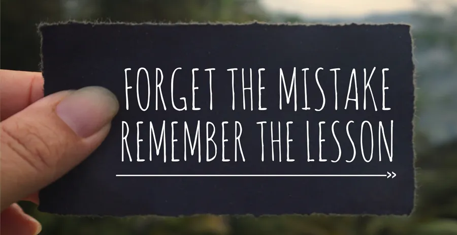 A hand holding a card that says, "Forget the Mistake, Remember the Lesson," symbolizing the powerful message of the Jelly Roll story and the journey of redemption and personal growth.