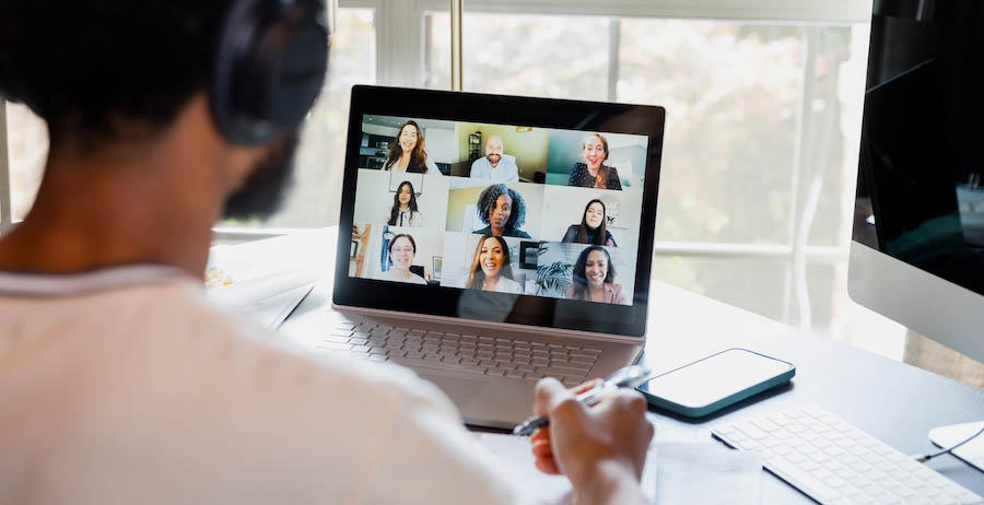 Man using workplace technology to participate in a video conference meeting.