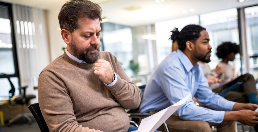 Group of diverse people at a local second chance job center waiting to speak to a counselor.